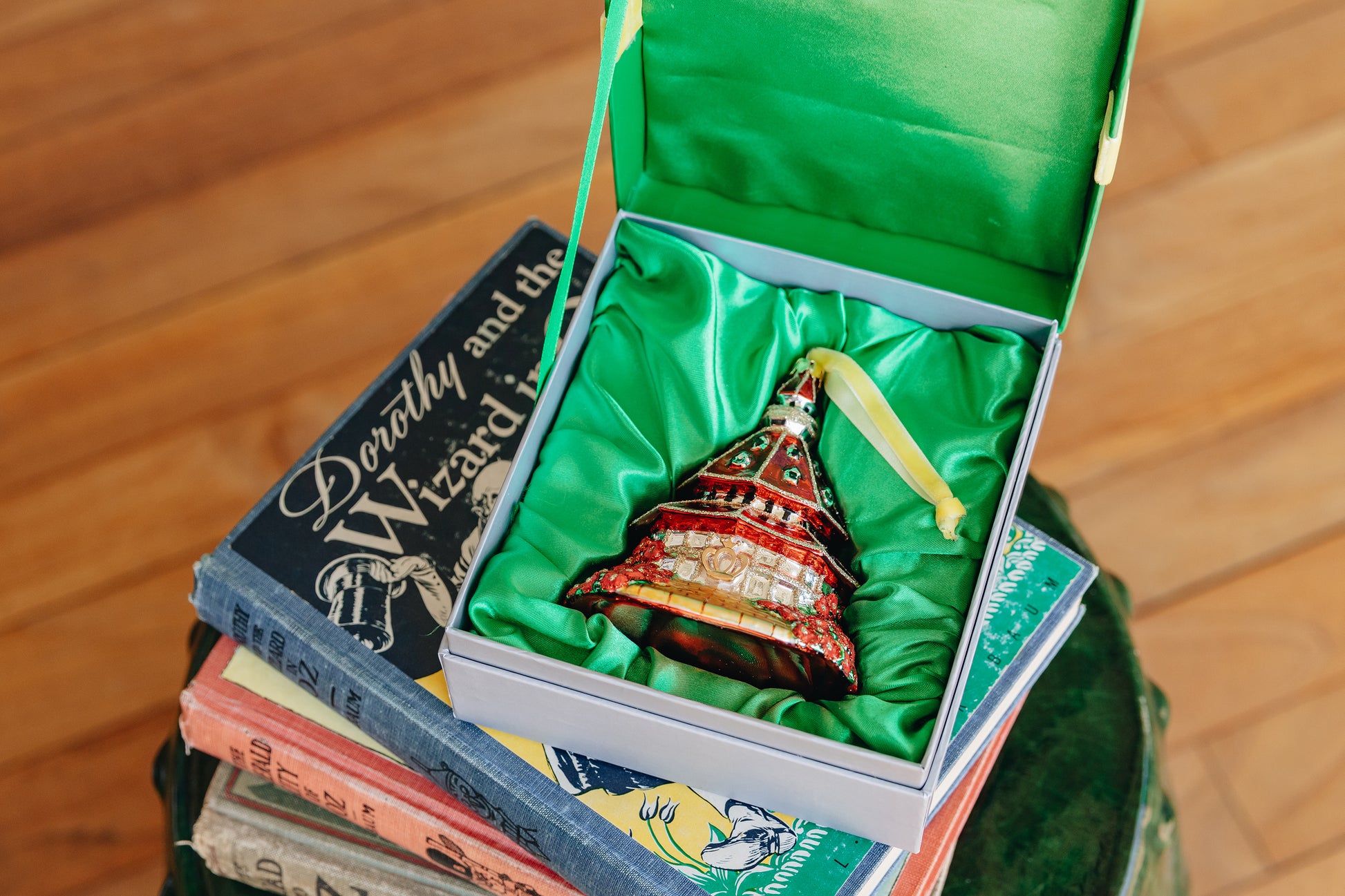 Hotel del Coronado ornament sitting in a padded gift box on a stack of Wizard of Oz books