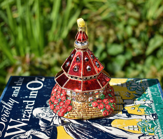 Ornament shaped like Hotel del Coronado turret with yellow brick road, poppies, and glitter accents.